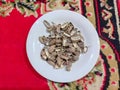 Bunch of peanut shells on a white plate Royalty Free Stock Photo