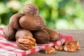 A bunch of pecan nuts on a wooden background Royalty Free Stock Photo