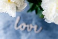 Bunch of peonies in the vase and vintage letters LOVE Royalty Free Stock Photo