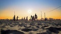 Bunch of people play beach volleyball at Beach