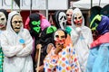 a bunch of people wearing halloween costumes and masks standing together