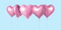 Bunch of pink color heart shaped foil balloons isolated on bright background. Minimal love concept Royalty Free Stock Photo