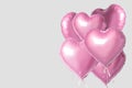 Bunch of pink color heart shaped foil balloons isolated on bright background. Minimal love concept