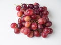 A bunch of pink large grapes on a white background