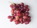 A bunch of pink large grapes on a white background