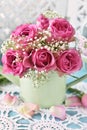 Bunch of pink roses in a mint watering can Royalty Free Stock Photo