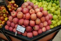 Bunch of pink, yellow and green apples on boxes in supermarket. Apples being sold at public market. Organic food Fresh apples in Royalty Free Stock Photo