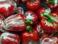 Bunch of plastic wrapped red bell peppers Royalty Free Stock Photo