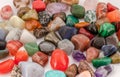 A bunch of polished gemstones, close-up. High-angle view. Colorful gemstones background.