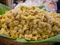 A bunch of pork streamed dumplings on a bannana leaf in a bamboo tray for sale - Thai Kanom Jeeb