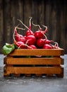 Bunch radish in wooden box at background