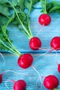 Bunch of radishes on wooden table, vertical shot, top view Royalty Free Stock Photo