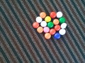 Bunch of Rainbow Sugar Coated Round Chocolate Balls on the Colorful Carpet