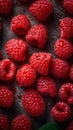 a bunch of raspberries sitting on top of a table next to a leafy green leafy green leafy green leafy plant Royalty Free Stock Photo