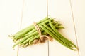 Bunch of raw green beans tied up with a string on white wooden table Royalty Free Stock Photo