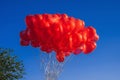 bunch of red balloons in shape of a heart on background of blue sky Royalty Free Stock Photo