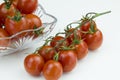 Bunch of red cherry tomatoes and tomatoes in glass bowl isolated on a white background Royalty Free Stock Photo