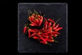 Bunch of red chillies on a plate and background