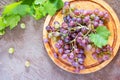 Bunch of red fresh grapes on a brown stone or slate background.