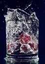 Bunch of red grapes falling down in water