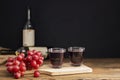 A bunch of red grapes with red grape juice in a glass placed on a wooden table or red wine, delicious natural healthy juice drink Royalty Free Stock Photo