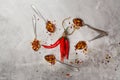 Bunch of red hot chilli peppers and flakes in spoons on grey stone kitchen table Royalty Free Stock Photo