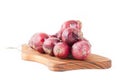 Bunch of red onions on wooden cutting board Royalty Free Stock Photo