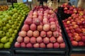 Bunch of red, pink and green apples on boxes in supermarket. Apples being sold at public market. Organic food Fresh apples in shop Royalty Free Stock Photo