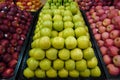 Bunch of red, pink, yellow and green apples on boxes in supermarket. Apples being sold at public market. Organic food Fresh apples Royalty Free Stock Photo