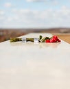 Bunch of red roses placed on marble stone wall at memorial tomb of mausoleum