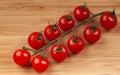 a bunch of red tomatoes on a wooden board