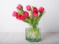 Bunch of red tulip flowers in a glass vintage jar Royalty Free Stock Photo