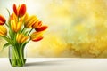 Bunch of red and yellow tulip flowers in a glass vase against colored plaster Royalty Free Stock Photo