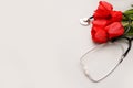 Bunch of redtulips and stethoscope on white background. National