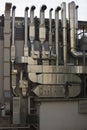 Vertical close up day shot of a bunch of restaurant kitchen stainless chimneys installed on a wall of a building Royalty Free Stock Photo