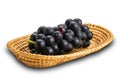 Bunch of ripe black grapes in bamboo tray isolated on white background Royalty Free Stock Photo