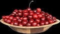 A bunch of ripe cherries lie on a plate, isolated on black. Ripe red berries, ripe fruits. Lots of burgundy cherries on a dark Royalty Free Stock Photo