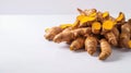 Bunch of ripe dried organic turmeric roots laid in composition on white background. Curcuma at table counter. Close up, flat lay,