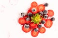 Bunch of ripe, fresh, natural red cut strawberries and blueberries, a healthy spring and summer fruit, on white background Royalty Free Stock Photo