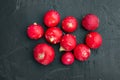 Bunch of ripe radishes, on black background, top view flat lay Royalty Free Stock Photo