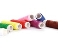 Bunch of rolls of colorful thread on a white surface