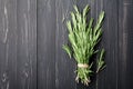 Bunch of rosemary plant on black rustic table from above