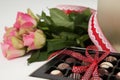 Bunch of roses and assorted chocolate box Royalty Free Stock Photo