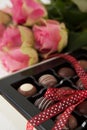 Bunch of roses and assorted chocolate box Royalty Free Stock Photo