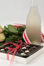 Bunch of roses, champagne bottle and assorted chocolate box Royalty Free Stock Photo