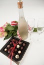 Bunch of roses, champagne bottle, wine glasses and assorted chocolate box Royalty Free Stock Photo