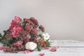 Bunch of roses and chrysanthemums on white paint wooden background.