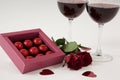 Bunch of roses, wine glasses and assorted chocolate box Royalty Free Stock Photo