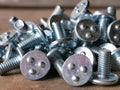 A bunch of round head all thread spot weld bolt screw on wooden table. Royalty Free Stock Photo