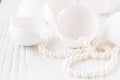 Bunch round white shiny pearls with white background